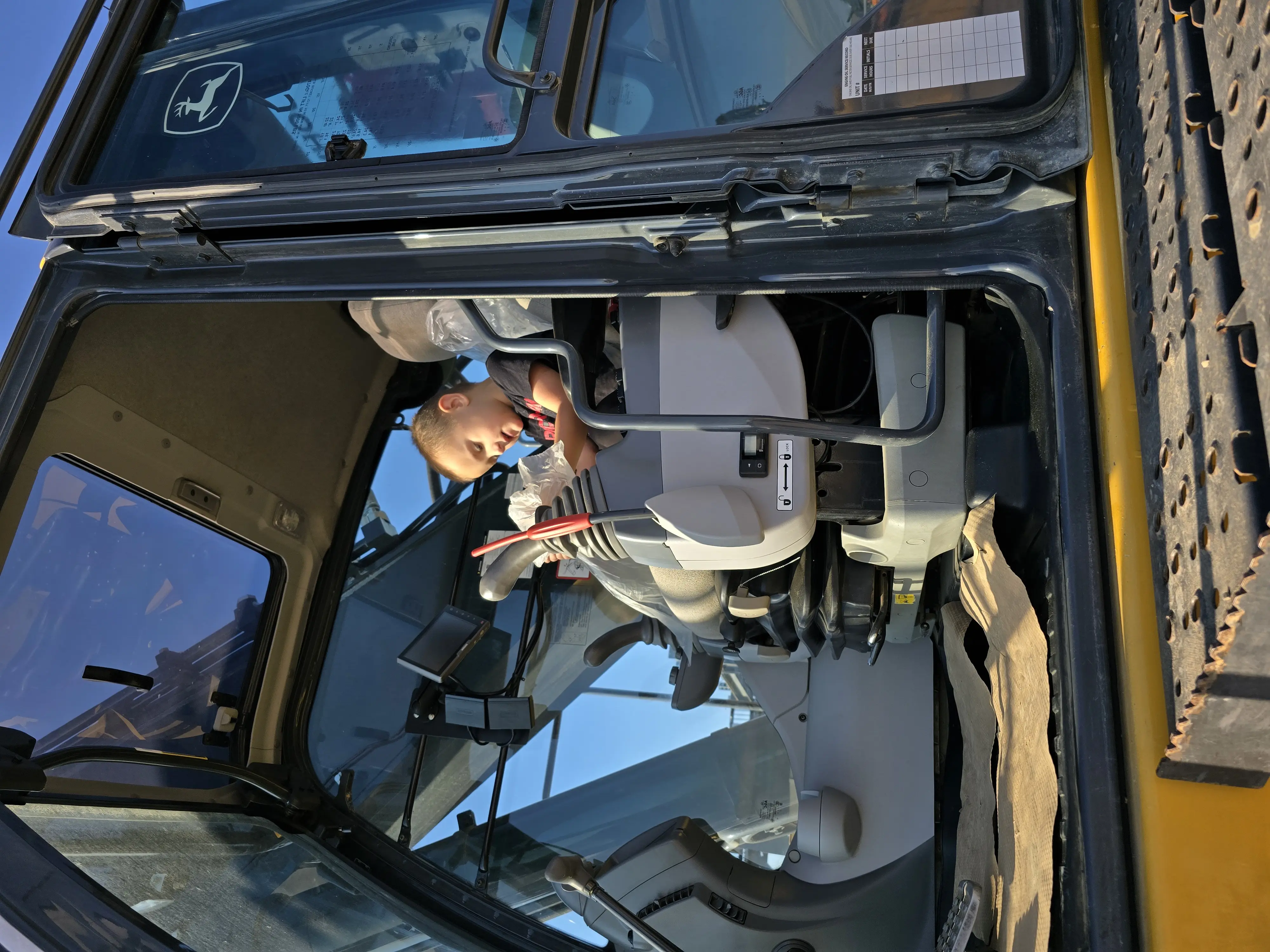 Child sitting in excavator